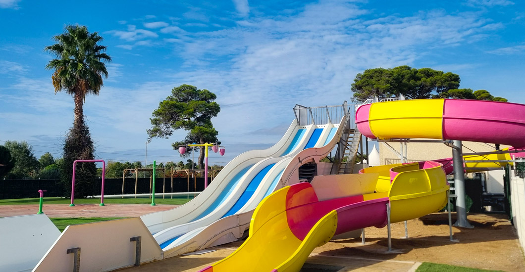 Swimming pool with slides at Vias Plage in 4-star Yelloh! Village campsite