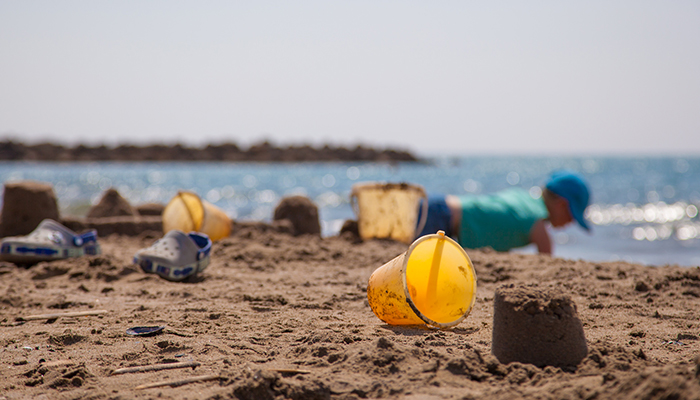 yellow seal, beach toys, child by the sea, sand castle, Vias beach in Hérault  